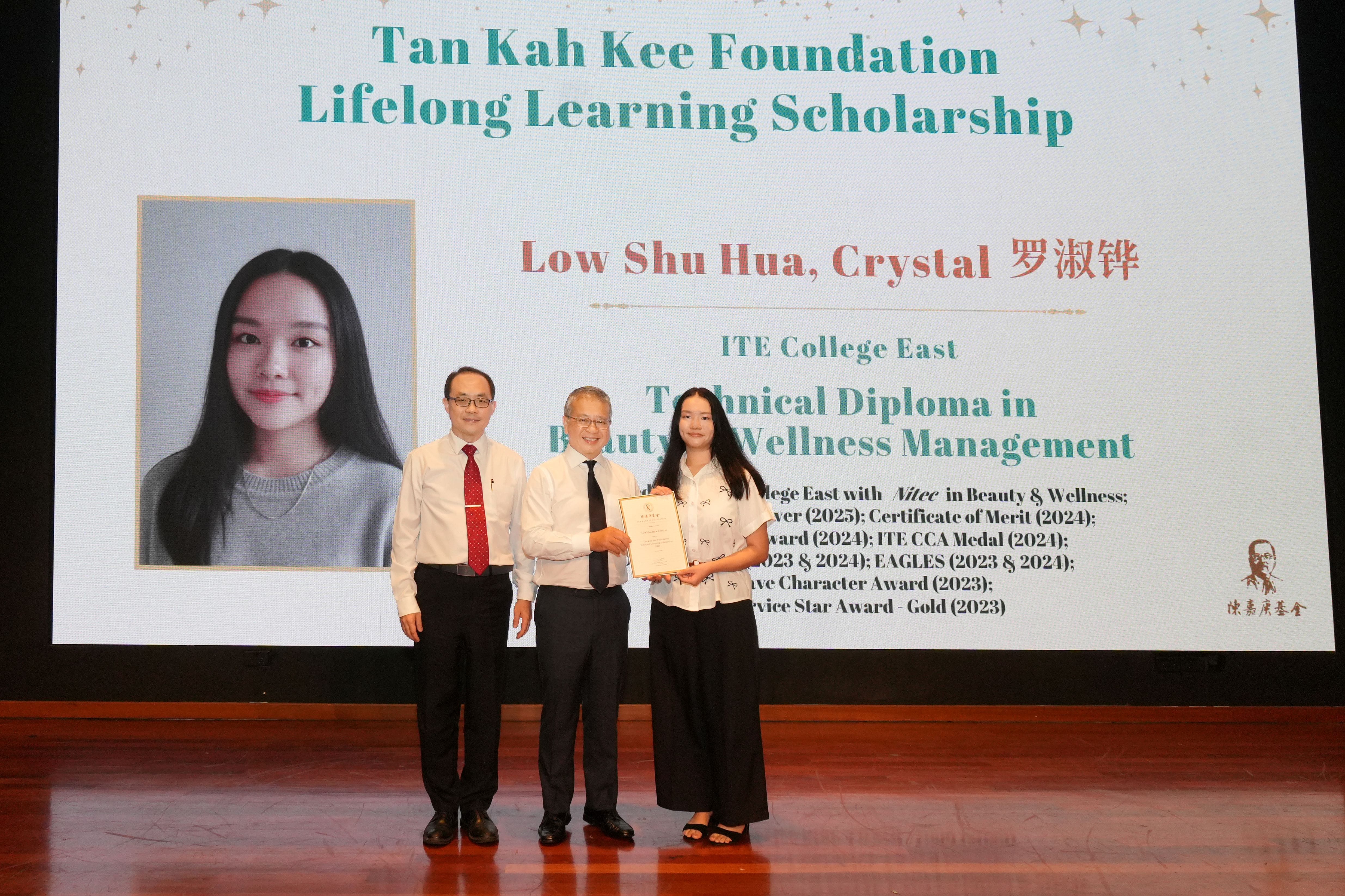 Recipient receiving scholarship on stage